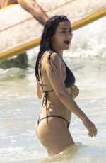CHARLI XCX in a Black Bikini at a Beach in Byron Bay 02/10/2025