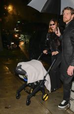 HAILEY BIEBER Out with Baby and Assistant on Rainy City Night 01/31/2025