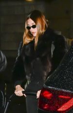 HAILEY BIEBER Out with Baby and Assistant on Rainy City Night 01/31/2025