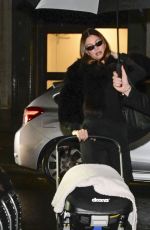 HAILEY BIEBER Out with Baby and Assistant on Rainy City Night 01/31/2025