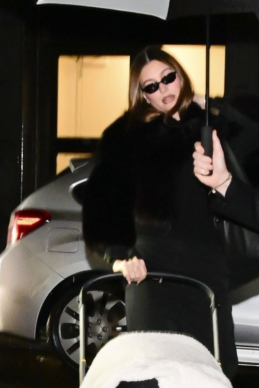 HAILEY BIEBER Out with Baby and Assistant on Rainy City Night 01/31/2025