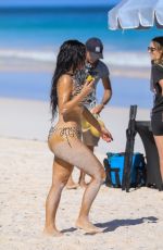 KIM KARDASHIAN in a Zebra Animal Print Bikini at a Beach Photoshoot in Bahamas 02/19/2025