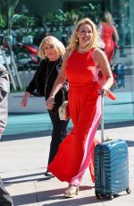 CLAIRE SWEENEY in a Belted Orange Jumpsuit Arrives at Vanessa Show 03/27/2025