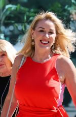 CLAIRE SWEENEY in a Belted Orange Jumpsuit Arrives at Vanessa Show 03/27/2025