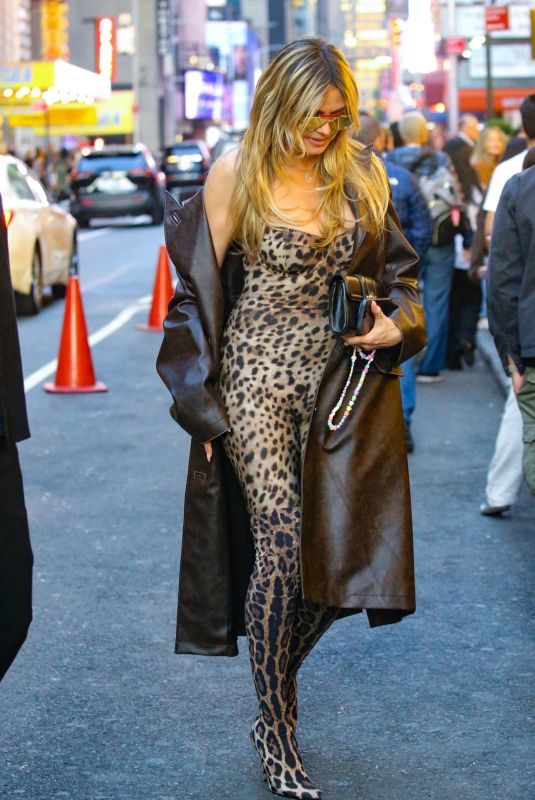 HEIDI KLUM in a Bold Leopard Print Catsuit and Leather Trench Coat Out in New York 04/23/2025