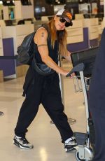 MELANIE CHISHOLM and Chris Dingwall Departing Sydney Airport 04/14/2025