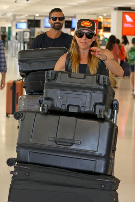 MELANIE CHISHOLM and Chris Dingwall Departing Sydney Airport 04/14/2025