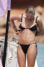 LILA GRACE MOSS and KIM TURNBULL in Bikinis with Friends at a Beach in Ibiza 06/12/2025