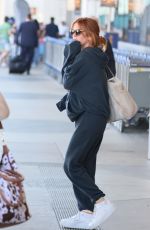 ISLA FISHER Arrives at LAX Airport in Los Angeles 08/03/2025