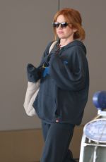 ISLA FISHER Arrives at LAX Airport in Los Angeles 08/03/2025