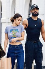 RACHEL ZEGLER and Nathan Louis Fernand Picks up a Jacket at a Charity Shop in London 08/31/2025