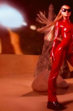 PARIS HILTON in a Tight Red Catsuit Dressed as Britney Spears in Oops I Did It Again 10/27/2025