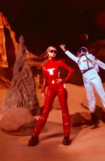 PARIS HILTON in a Tight Red Catsuit Dressed as Britney Spears in Oops I Did It Again 10/27/2025