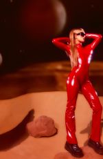 PARIS HILTON in a Tight Red Catsuit Dressed as Britney Spears in Oops I Did It Again 10/27/2025