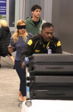 ADDISON RAE Wears a Blindfold at LAX Airport in Los Angeles 11/19/2025