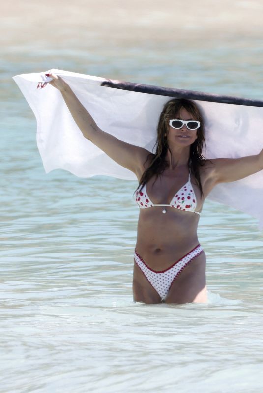 HEIDI KLUM in Bikini at a Beach in St Barths 12/28/2025