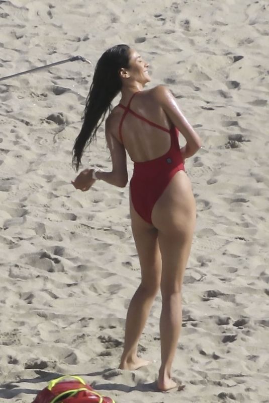 SHAY MITCHELL in a Red Swimsuit Films Scenes for Baywatch Reboot at Leo Carrillo Beach in Malibu 04/08/2026