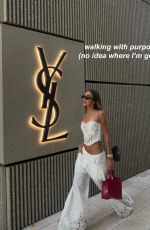 LUANA BARRON Promotes Saint Laurent in a White Dress Out in Miami 05/12/2026