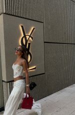 LUANA BARRON Promotes Saint Laurent in a White Dress Out in Miami 05/12/2026