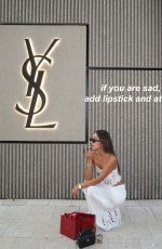 LUANA BARRON Promotes Saint Laurent in a White Dress Out in Miami 05/12/2026