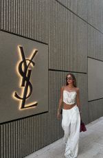 LUANA BARRON Promotes Saint Laurent in a White Dress Out in Miami 05/12/2026