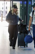 ELLIE GOULDING and Beau Minniear Jet Out of London Ahead of Taylor Swift